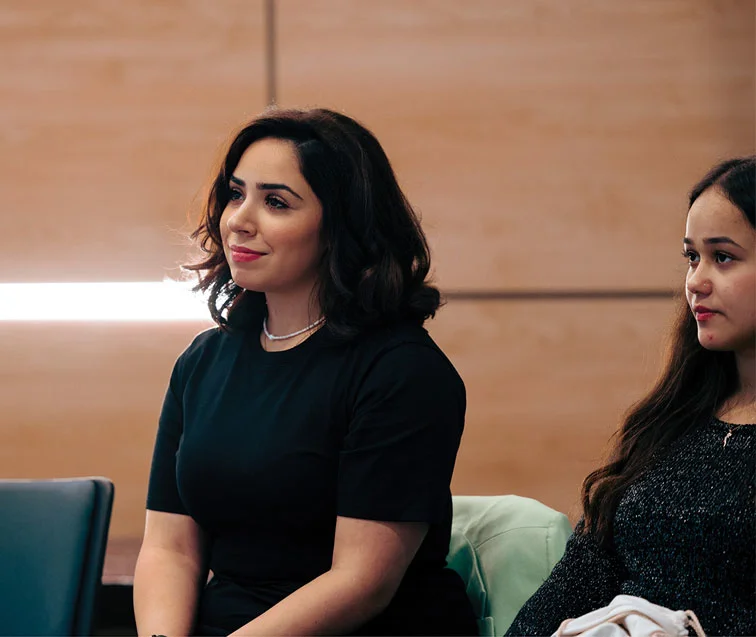 An engaged audience attentively watching a performance at AUK.