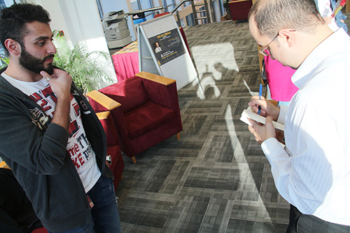 Auk library holds a poetry reading and book signing for yousef nayef