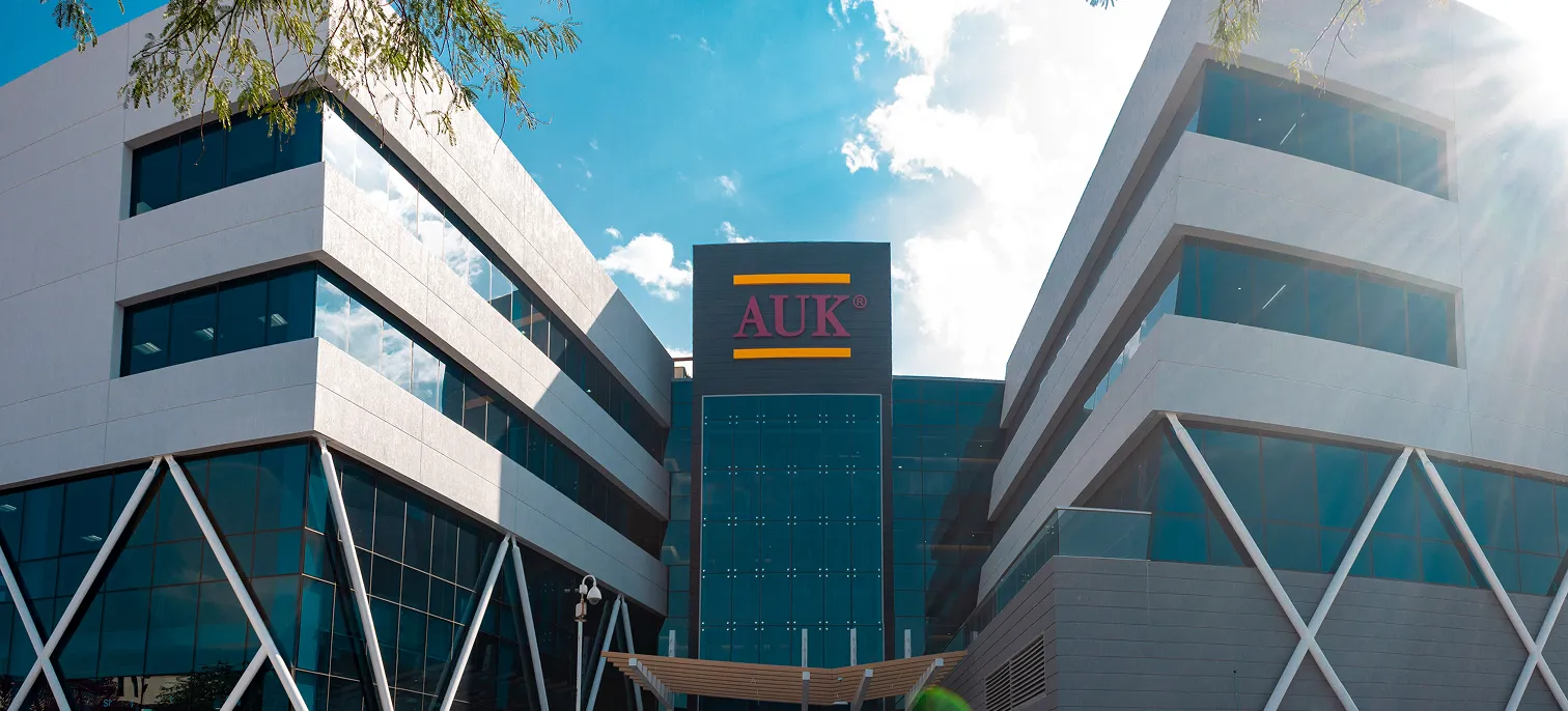 The iconic main building of AUK, showcasing its elegant modern architecture and welcoming entryway.