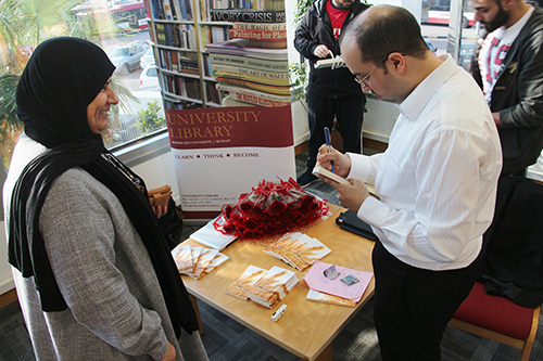 Auk library holds a poetry reading and book signing for yousef nayef