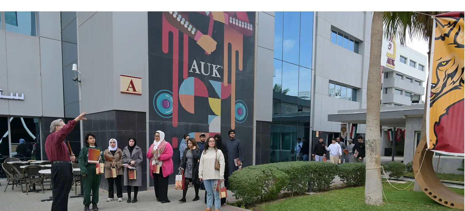 A professor leading a guided campus tour at AUK, showcasing modern facilities, amenities, and inspiring surroundings.