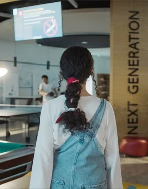A new student exploring the indoor sports lounge at AUK.