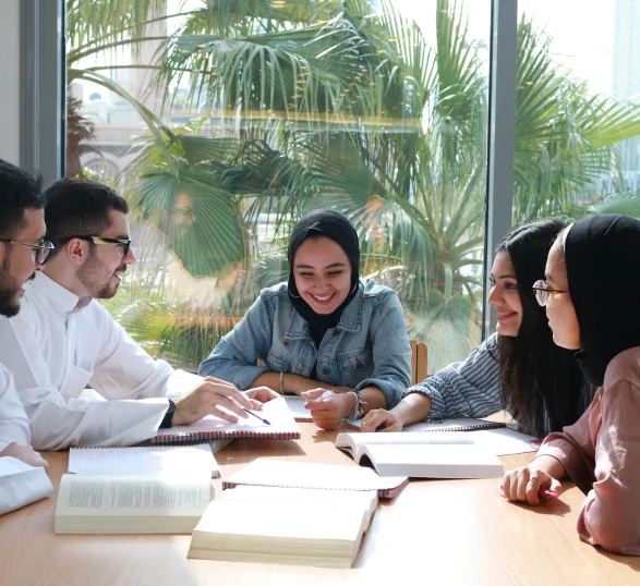 A group of AUK students working together on a group study session, showcasing teamwork and academic focus.