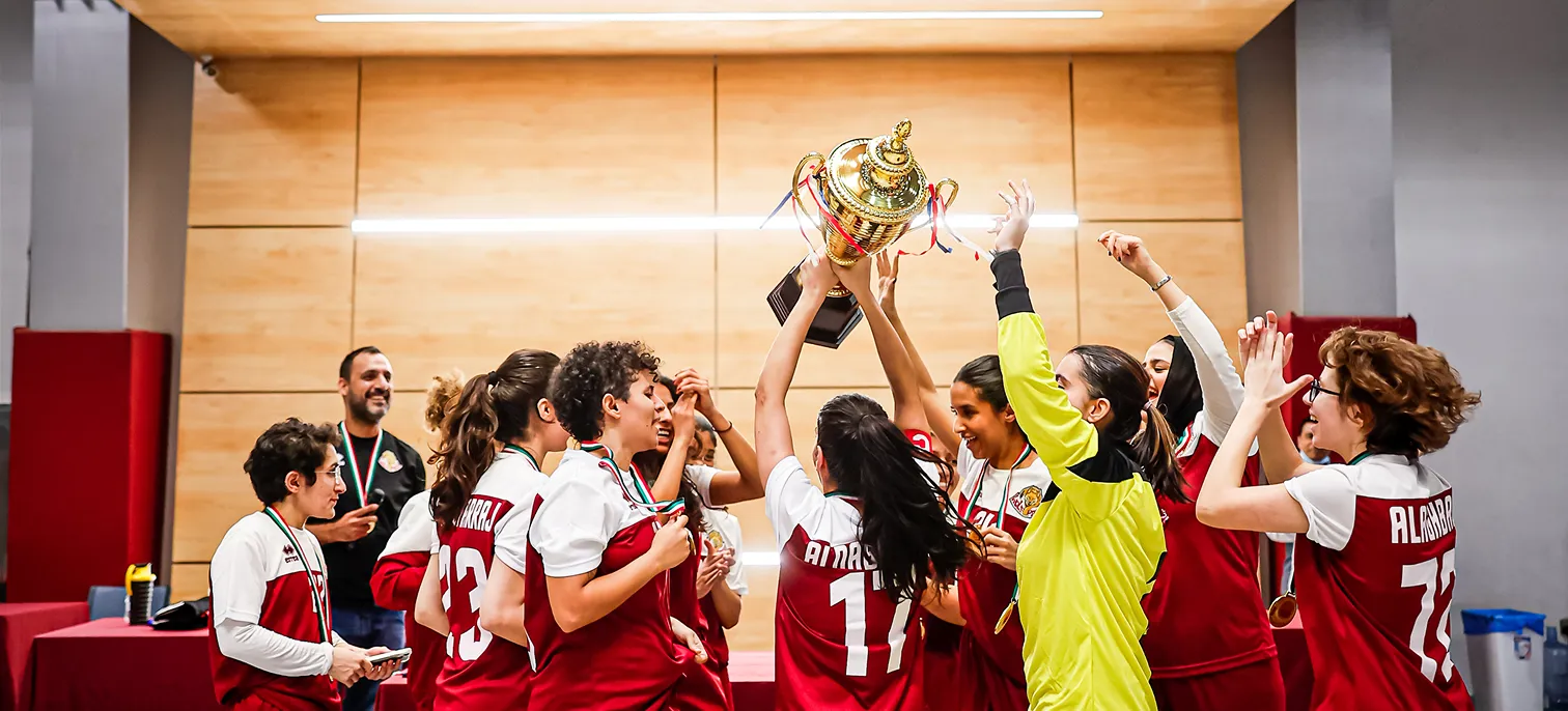A group of AUK students celebrating and enjoying a competitive and team-building experience on campus.