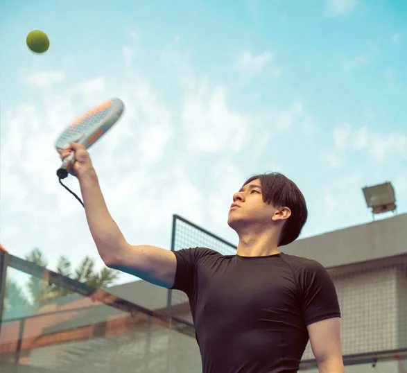An AUK student practicing their tennis skills on the court
