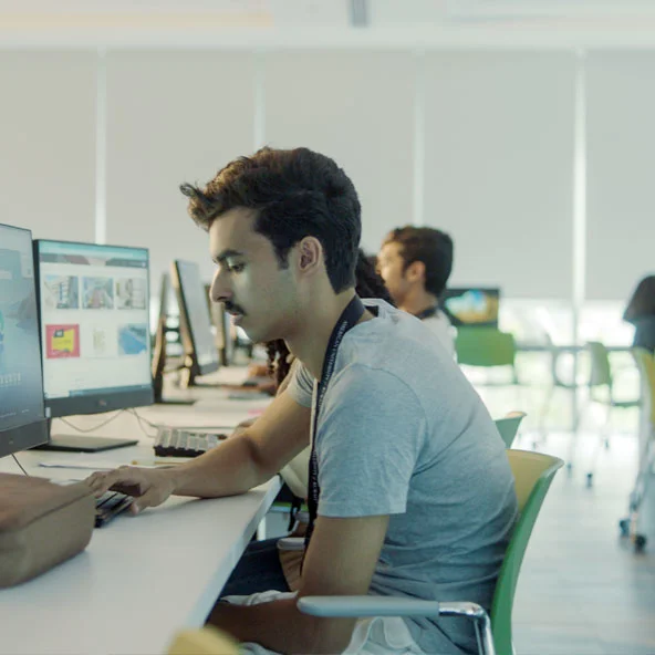 An AUK student exploring academic resources at the university library.