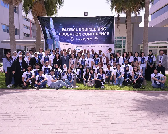 A group of AUK students posing for a memorable photo after their activities and events celebrations