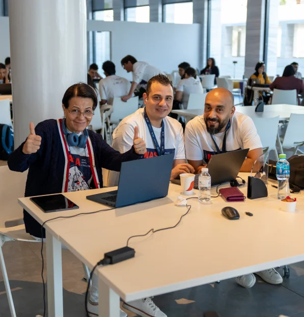Three AUK faculty members deeply engrossed in a meaningful conversation, fostering intellectual exchange.